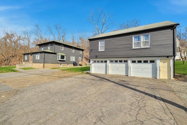 exterior space with aphalt driveway and a garage