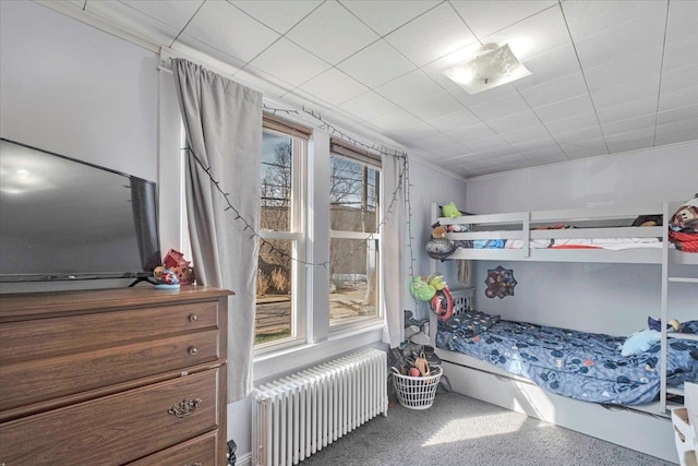 bedroom featuring radiator and crown molding