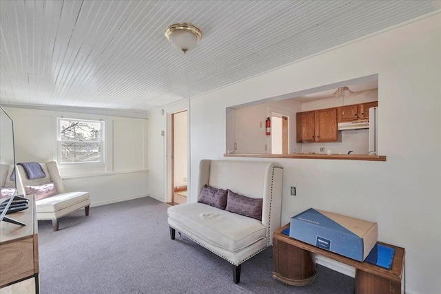 living area featuring wood ceiling and carpet flooring