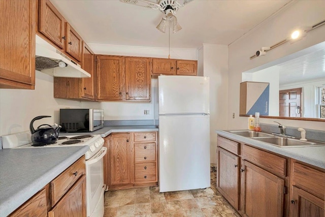 kitchen with a sink, white appliances, brown cabinets, ceiling fan, and under cabinet range hood