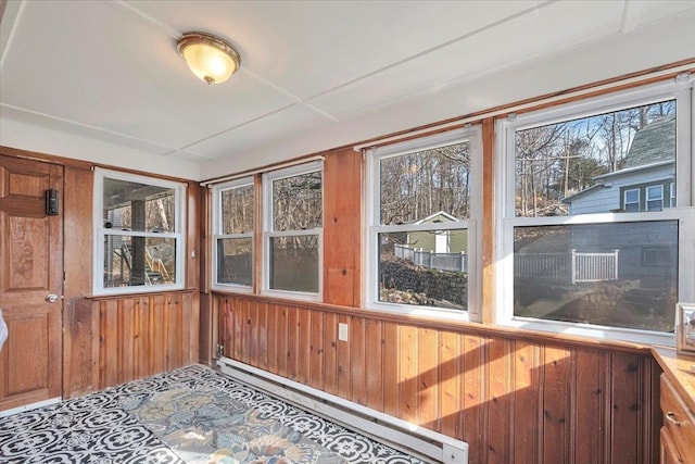 unfurnished sunroom featuring baseboard heating