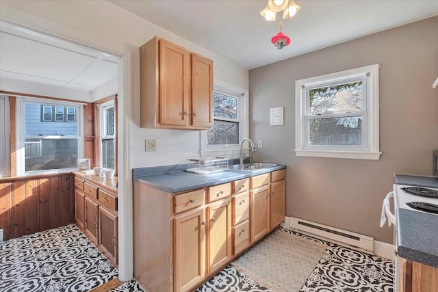 kitchen with a baseboard heating unit, dark countertops, electric stove, and a sink