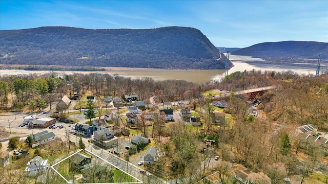 birds eye view of property featuring a water and mountain view