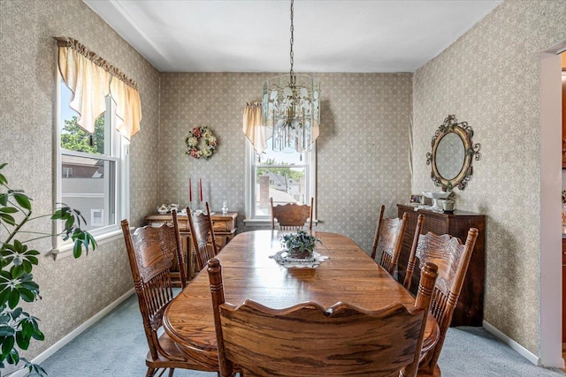 35-30 211th St, Bayside, NY 11361 - carpeted dining space featuring healthy amount of natural light, a chandelier, wallpapered walls, and baseboards