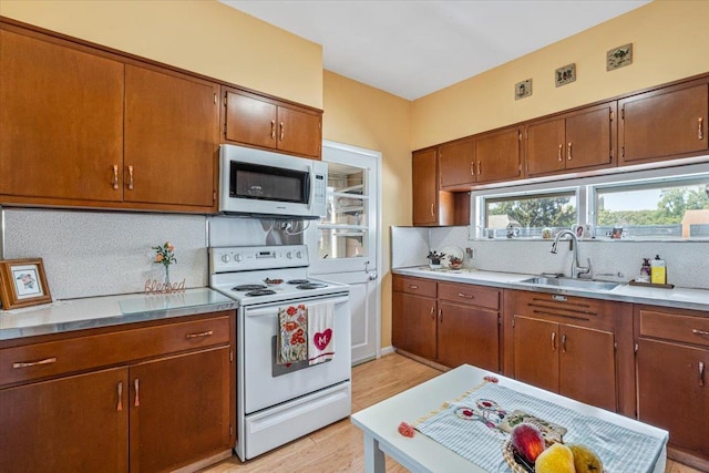 35-30 211th St, Bayside, NY 11361 - kitchen featuring white appliances, a sink, tasteful backsplash, and light wood-type flooring
