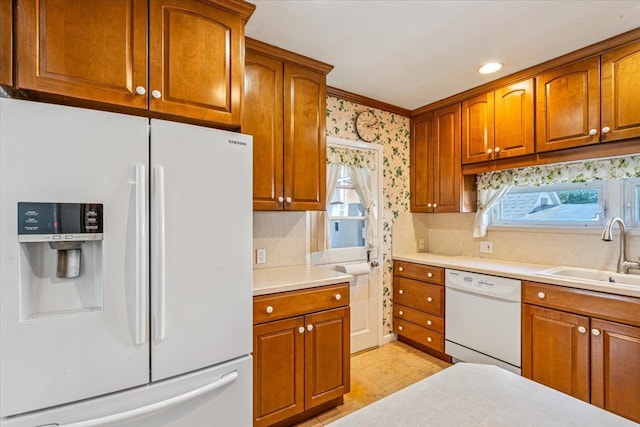 35-30 211th St, Bayside, NY 11361 - kitchen featuring white appliances, a sink, brown cabinetry, crown molding, and recessed lighting