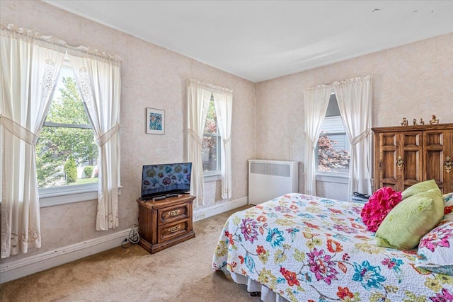 35-30 211th St, Bayside, NY 11361 - carpeted bedroom featuring radiator heating unit, multiple windows, and baseboards