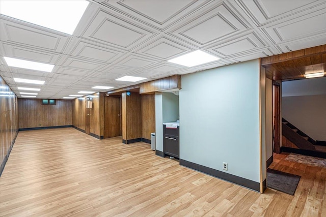 35-30 211th St, Bayside, NY 11361 - finished below grade area featuring light wood-type flooring, baseboards, stairs, and wooden walls
