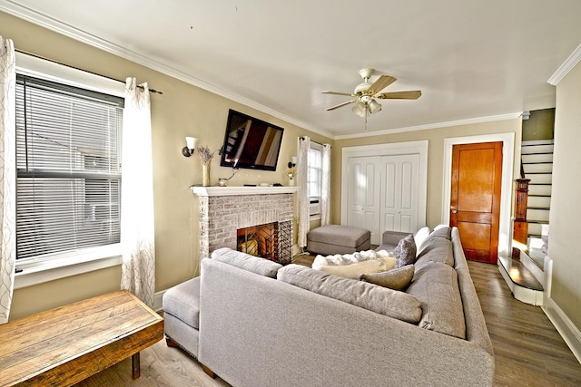 9249 Springfield Blvd, Queens Village, NY 11428 - living room featuring ornamental molding, ceiling fan, wood finished floors, a fireplace, and baseboards