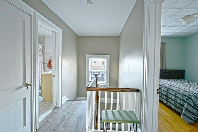 9249 Springfield Blvd, Queens Village, NY 11428 - hall with wood finished floors and an upstairs landing