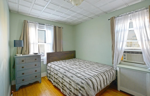 9249 Springfield Blvd, Queens Village, NY 11428 - bedroom featuring radiator, wood finished floors, and cooling unit
