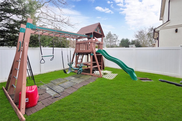 view of playground featuring a lawn and a fenced backyard