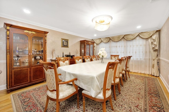 dining area with recessed lighting, ornamental molding, and light wood-type flooring