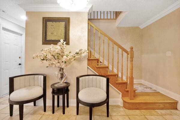 interior space with baseboards, ornamental molding, and tile patterned flooring