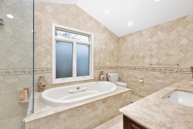 bathroom with tile walls, a bath, and vanity
