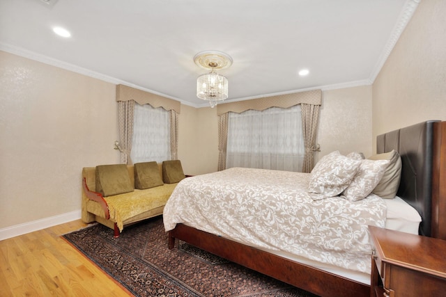bedroom with ornamental molding, wood finished floors, baseboards, recessed lighting, and a chandelier