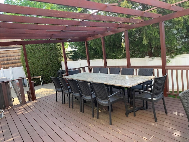 wooden deck featuring a fenced backyard, a pergola, and outdoor dining area
