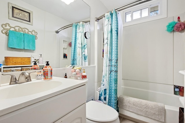 full bath with toilet, vanity, and shower / tub combo with curtain
