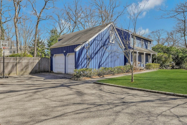 exterior space featuring driveway and fence