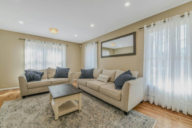 living area with recessed lighting and wood finished floors