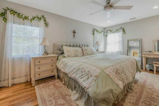 bedroom with visible vents, ceiling fan, and light wood-type flooring