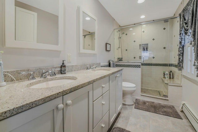 bathroom featuring a stall shower, a baseboard radiator, toilet, and a sink