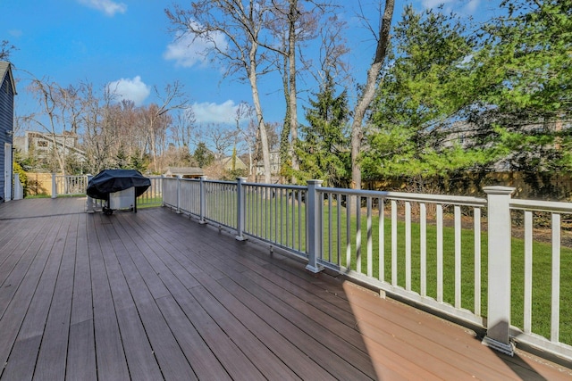 wooden deck featuring a yard