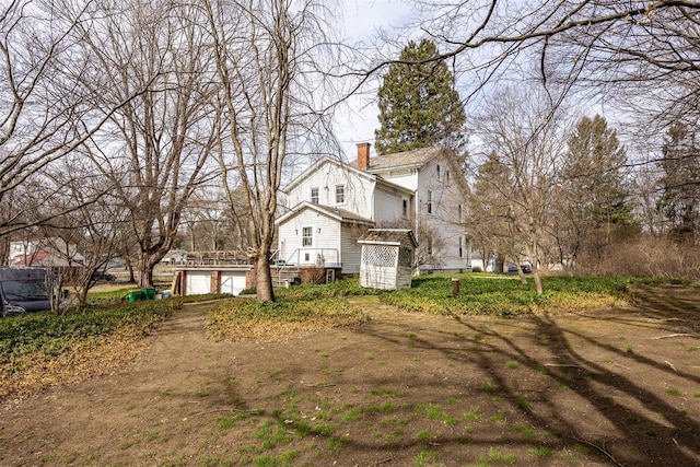 655 Vassar Rd, Poughkeepsie, NY 12603 - view of side of home featuring an attached garage and a chimney