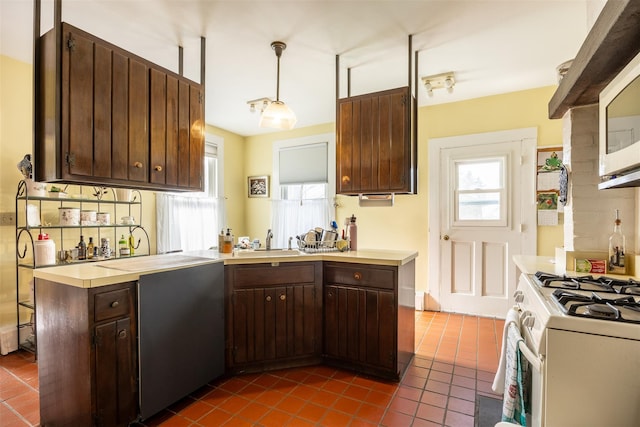 655 Vassar Rd, Poughkeepsie, NY 12603 - kitchen with light countertops, dark tile patterned flooring, tasteful backsplash, and dark brown cabinets