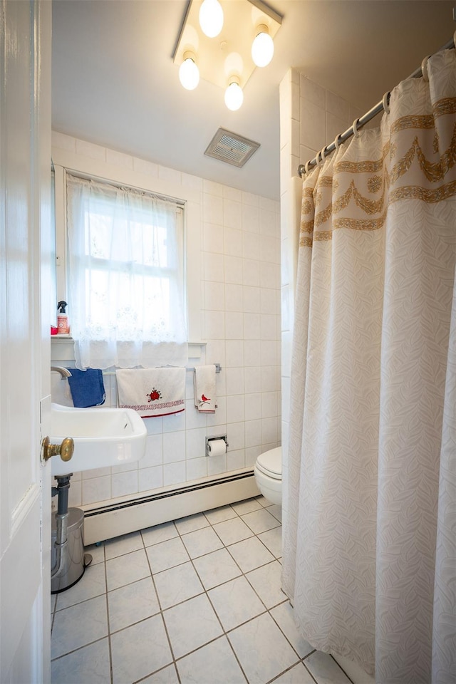 655 Vassar Rd, Poughkeepsie, NY 12603 - bathroom with tile walls, tile patterned floors, toilet, visible vents, and a baseboard radiator