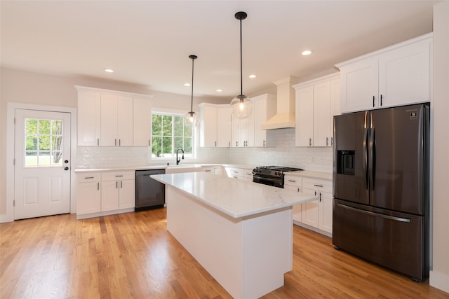 651 Vassar Rd, Poughkeepsie, NY 12603 - kitchen with custom range hood, white cabinetry, black dishwasher, stainless steel refrigerator with ice dispenser, and range with gas cooktop