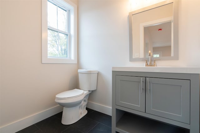 651 Vassar Rd, Poughkeepsie, NY 12603 - half bath with toilet, vanity, baseboards, and tile patterned flooring