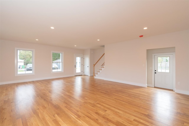 651 Vassar Rd, Poughkeepsie, NY 12603 - unfurnished living room with recessed lighting, light wood-style flooring, and a healthy amount of sunlight