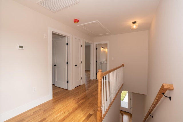 651 Vassar Rd, Poughkeepsie, NY 12603 - hallway featuring light wood-style flooring, visible vents, attic access, an upstairs landing, and baseboards