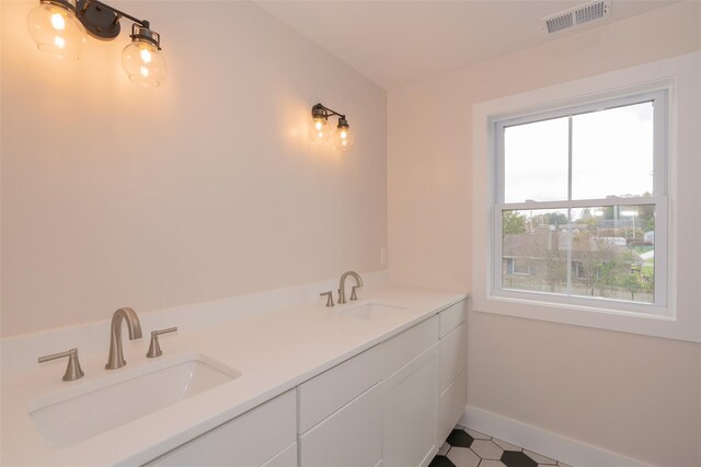 651 Vassar Rd, Poughkeepsie, NY 12603 - bathroom with a sink, visible vents, and baseboards
