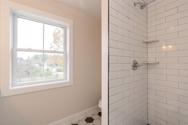 651 Vassar Rd, Poughkeepsie, NY 12603 - bathroom with baseboards, a tile shower, and toilet