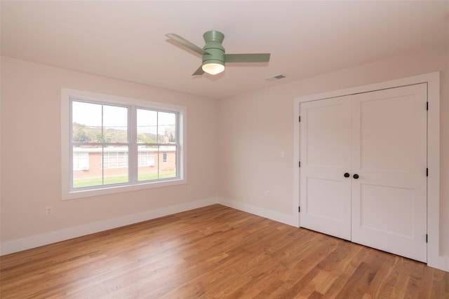 651 Vassar Rd, Poughkeepsie, NY 12603 - unfurnished bedroom featuring a closet, light wood-type flooring, baseboards, a ceiling fan, and visible vents