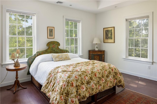 bedroom featuring dark wood-type flooring, baseboards, and visible vents