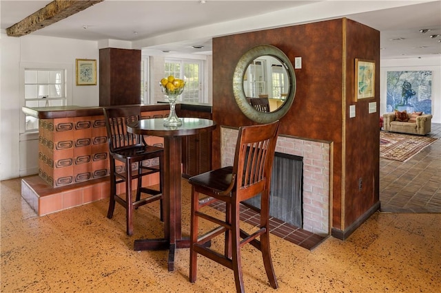 dining space with beamed ceiling
