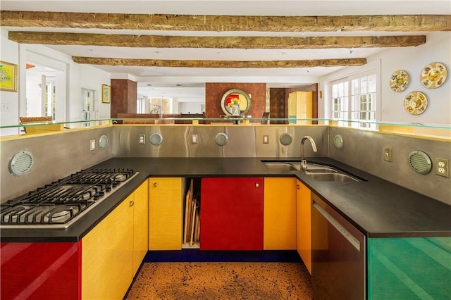 kitchen featuring beamed ceiling, dark countertops, appliances with stainless steel finishes, a sink, and backsplash