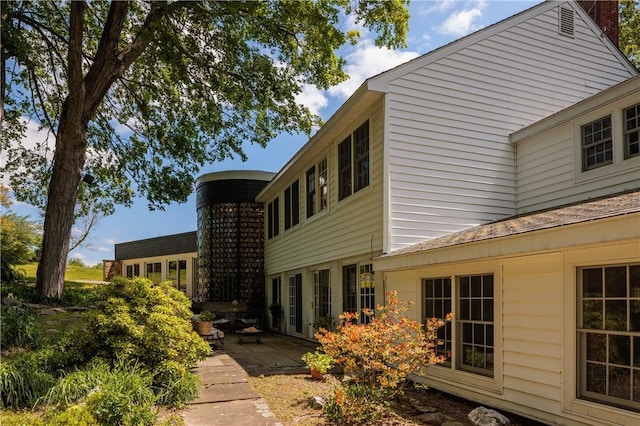 view of property exterior with a patio area