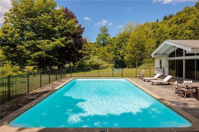 view of swimming pool with a fenced in pool, a lawn, fence, and a patio area