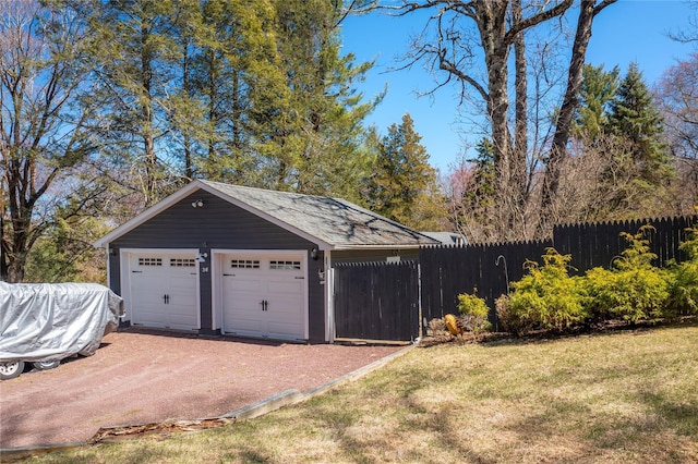 detached garage featuring fence