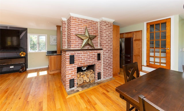 living room with light wood-type flooring, baseboards, visible vents, and a fireplace