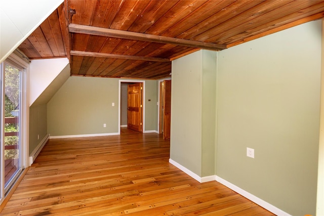 bonus room featuring vaulted ceiling, wooden ceiling, baseboards, a baseboard heating unit, and light wood-style floors