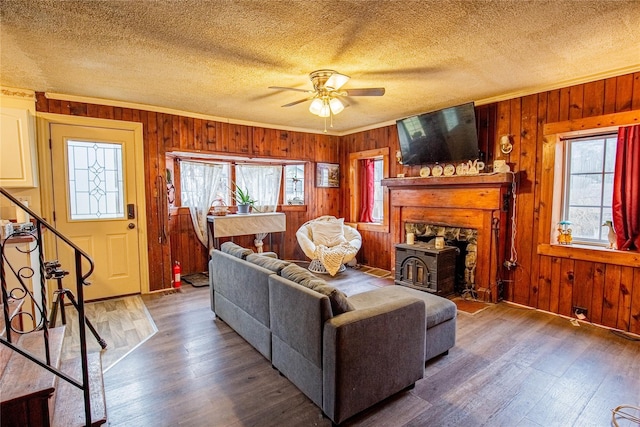 living area featuring ornamental molding, a healthy amount of sunlight, and wood-type flooring