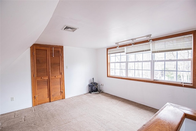 spare room featuring carpet flooring and visible vents