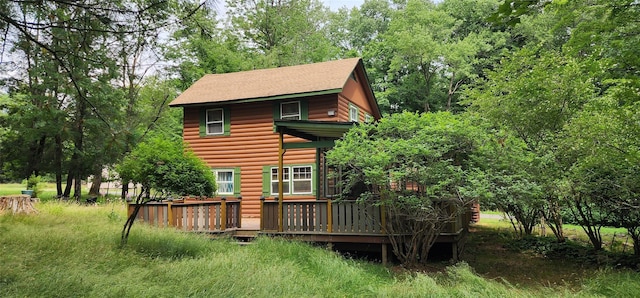 22 Ballard St, Smallwood, NY 12778 - back of property featuring a shingled roof, a wooden deck, and faux log siding