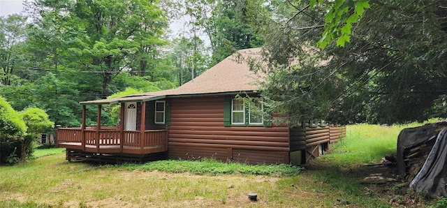 22 Ballard St, Smallwood, NY 12778 - view of home's exterior featuring a lawn, log veneer siding, and a deck