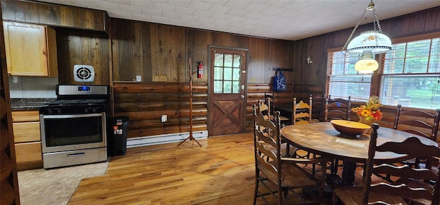 22 Ballard St, Smallwood, NY 12778 - dining space with light wood finished floors, rustic walls, visible vents, and a baseboard heating unit